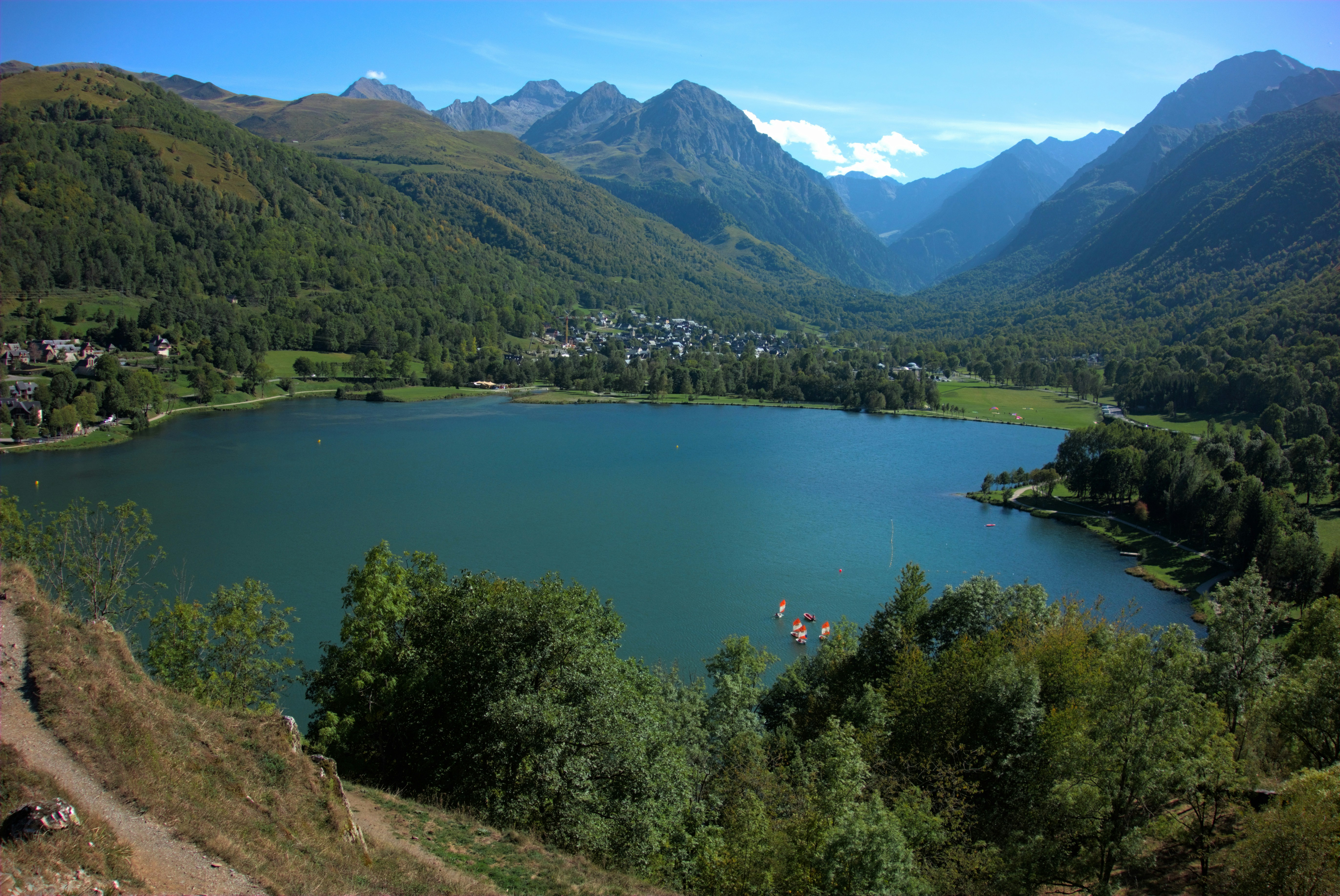 a lake surrounded by trees and mountains