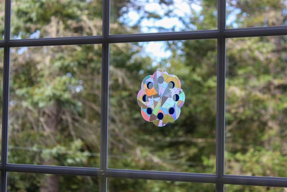 a colorful balloon from a metal fence