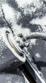 Detail of zinc-rich coating being sprayed on an exterior pipeline