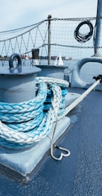 Close-up of strong nautical ropes coiled neatly on a boat deck.