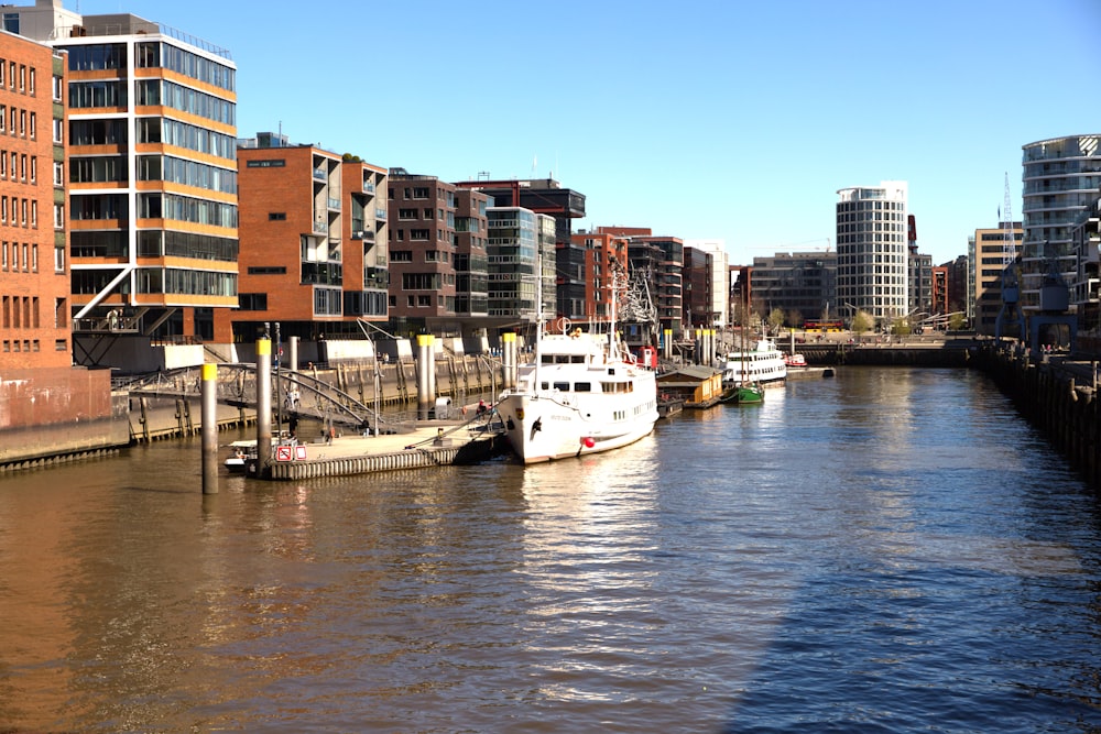 a boat in a body of water with buildings around it