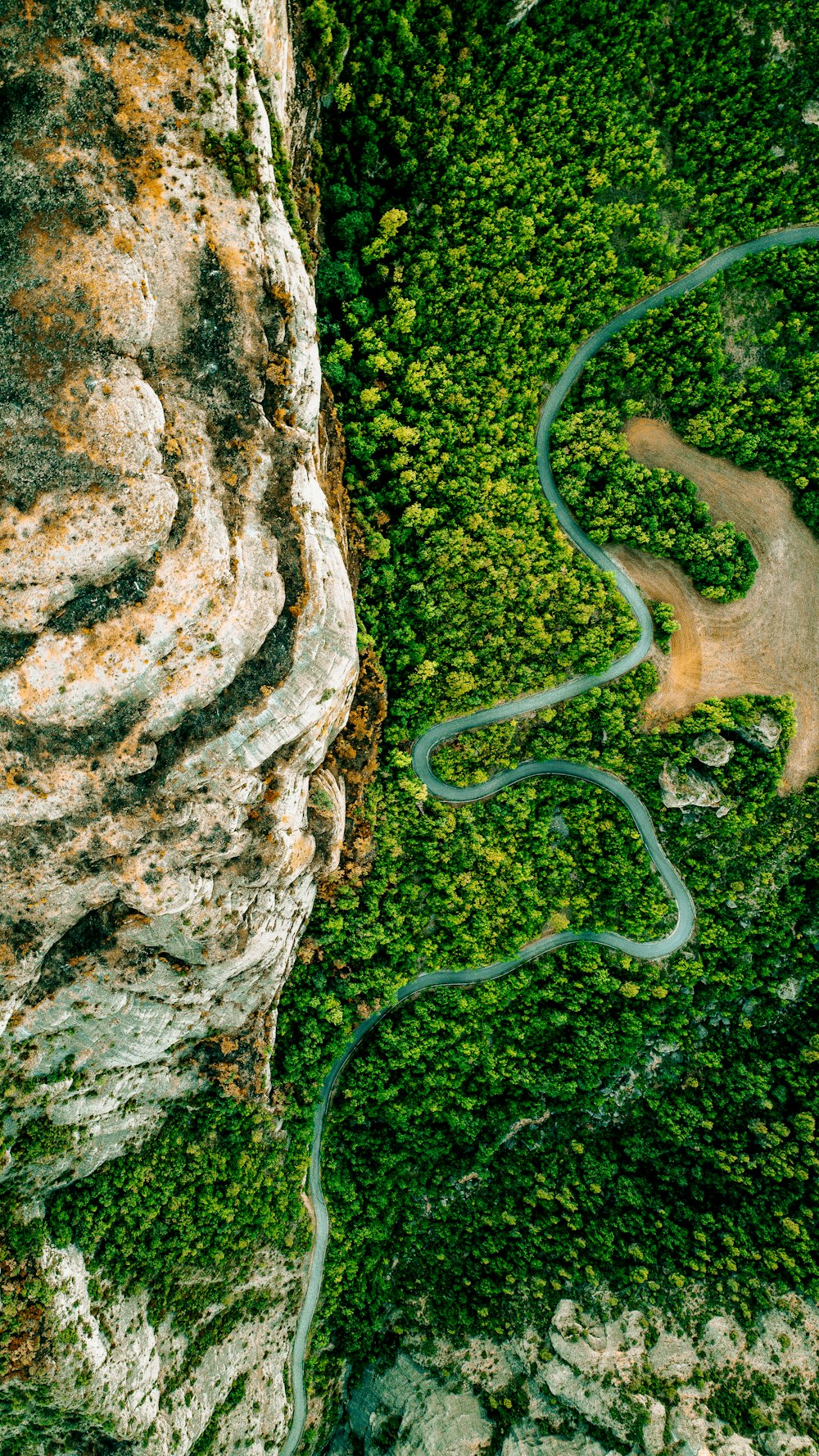 a winding road through a rocky area