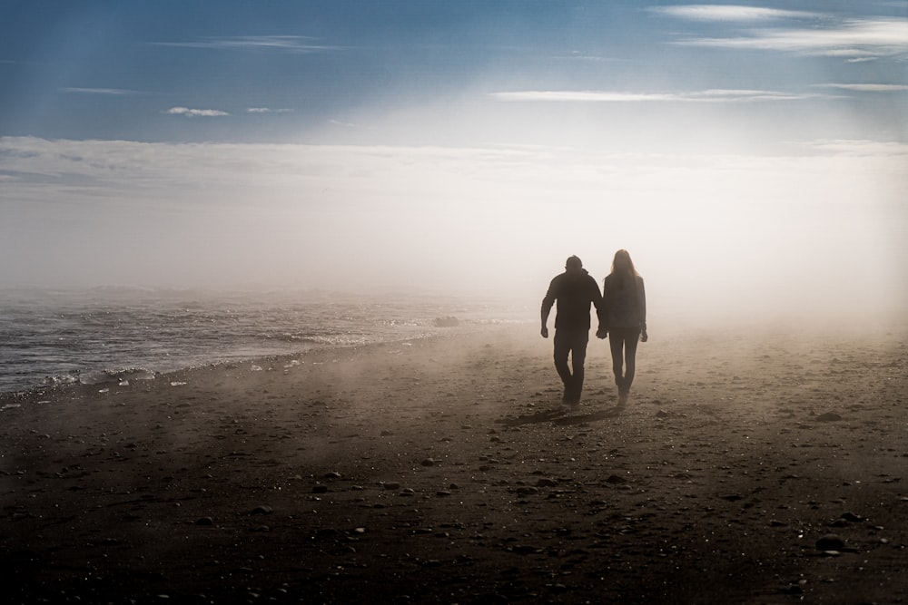 a couple walking on a beach
