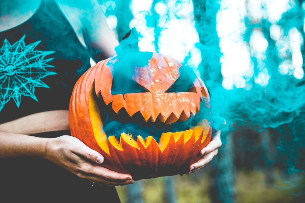 a person holding a pumpkin