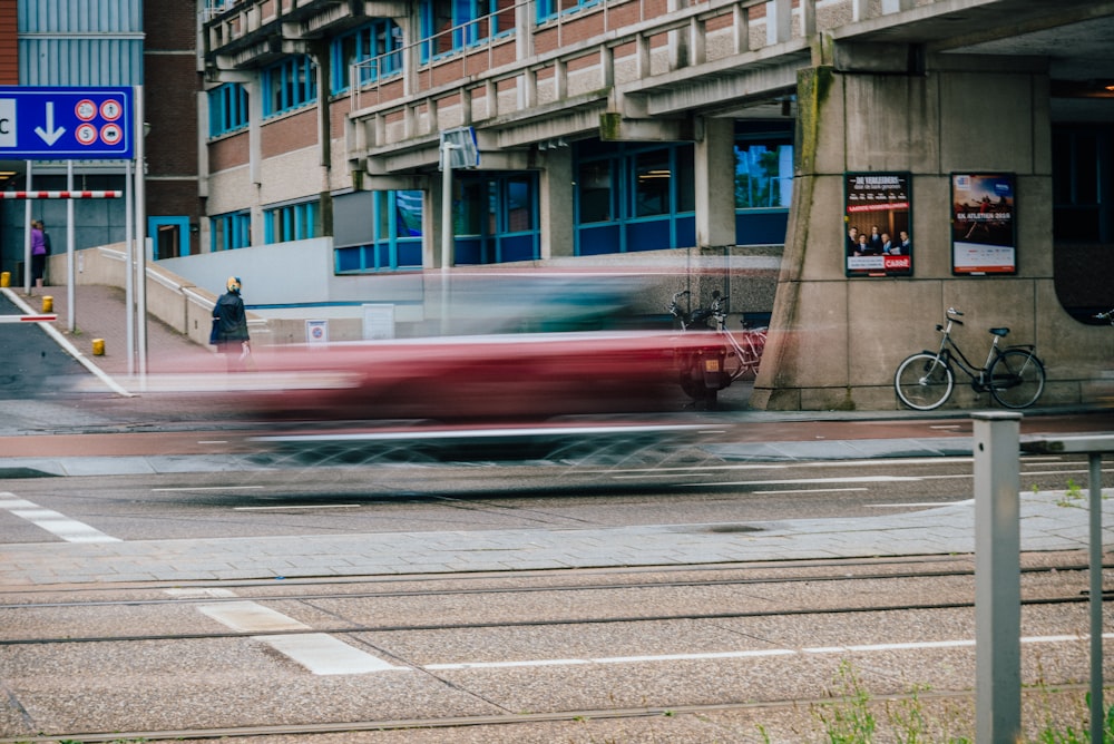 a street with a car and a building in the background