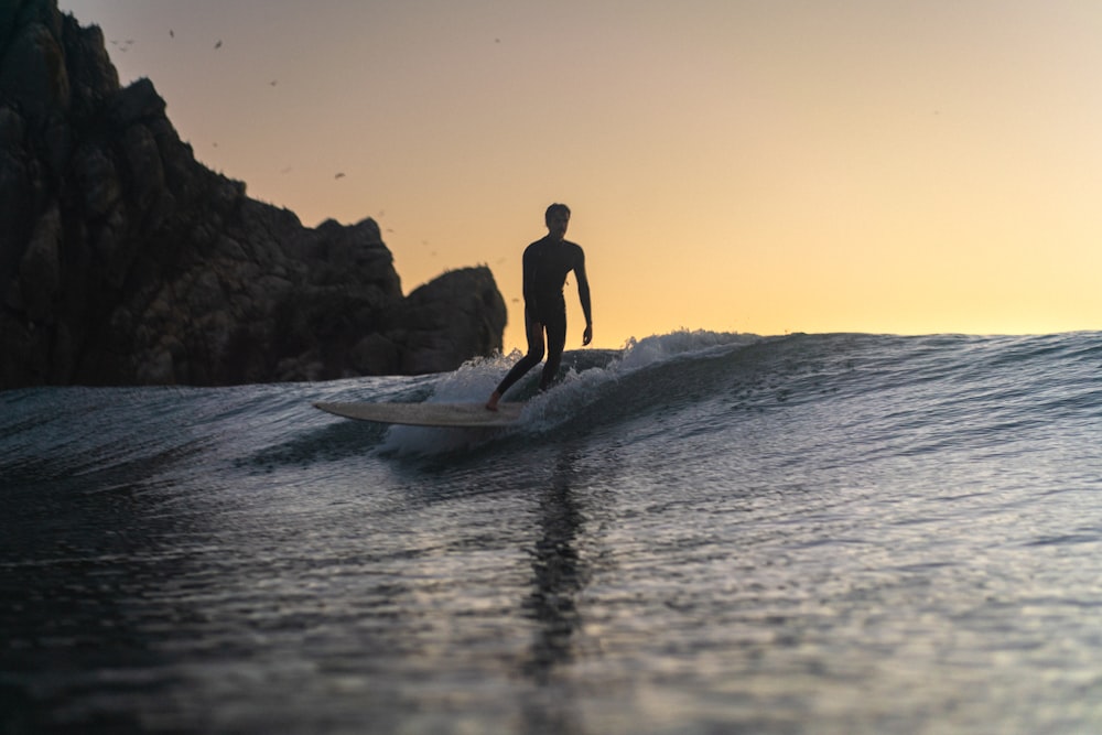 a man riding a surfboard