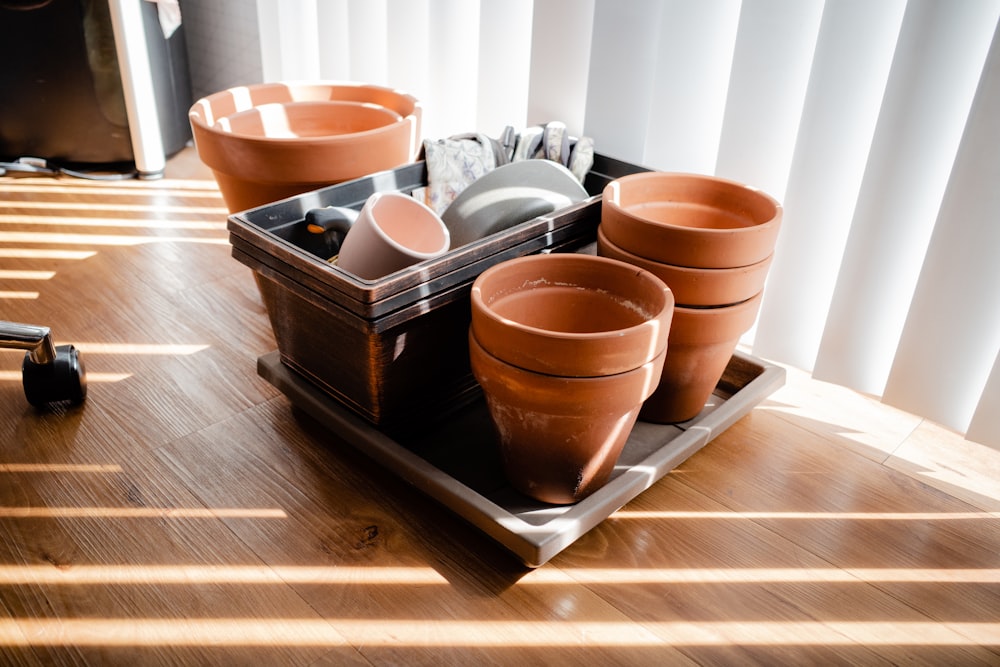 a cup of coffee sitting on top of a wooden table