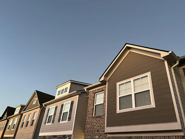Evening shot of completed Bodwin Group homes with warm lights glowing, symbolizing comfort and community.