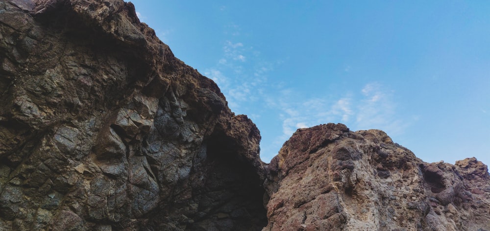 a rocky cliff with a blue sky
