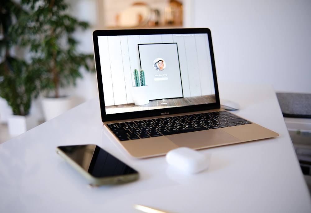 a laptop and a cell phone on a table