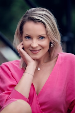 photography poses for women,how to photograph close up portrait of a beautiful young woman dressed in a pink dress, leaning head in hand. model sofie (instagram: @sofiepersson87) in stockholm, sweden.; a woman with her hand on her face