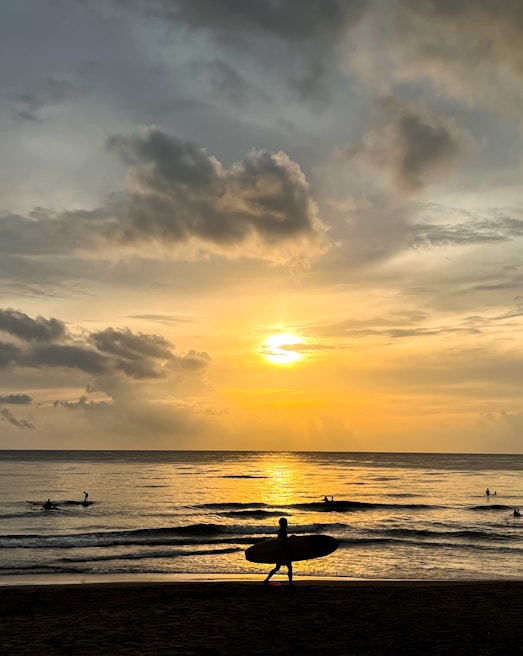 A dramatic still from the television drama Sunset Surfer M.D., featuring the main character gazing thoughtfully at a sunset over the ocean.