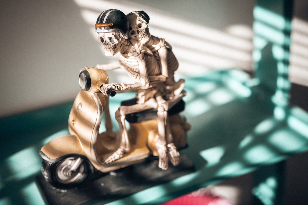 a couple of toy figurines on a toy motorcycle
