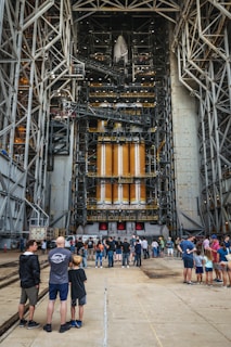 a group of people standing in front of a large metal structure