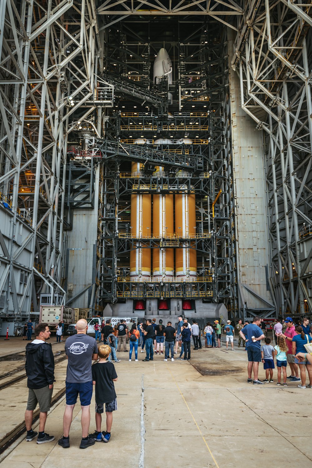 a group of people standing in front of a large metal structure