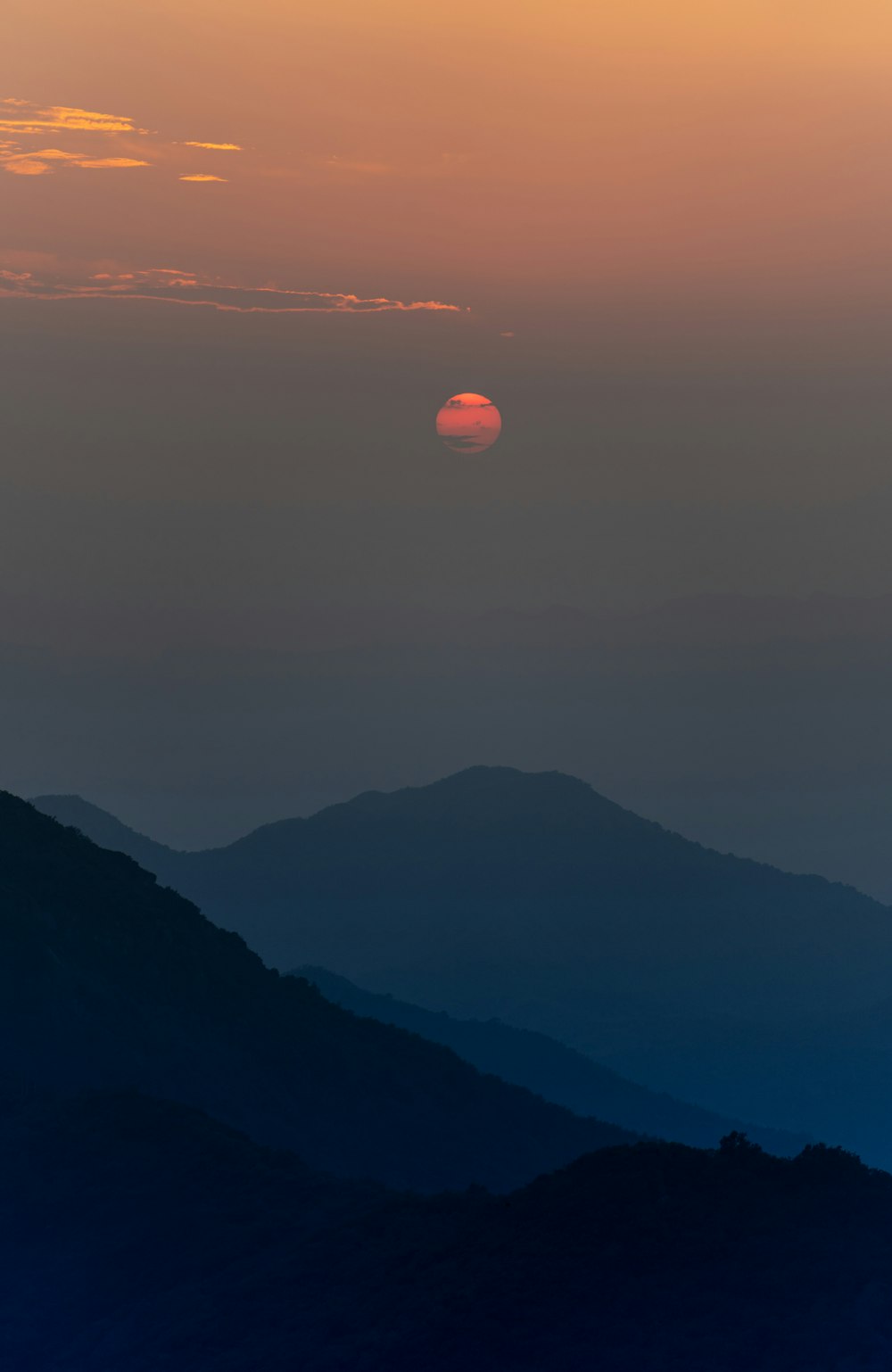 a sunset over a mountain