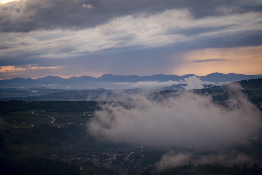 a view of a mountain range and clouds from above