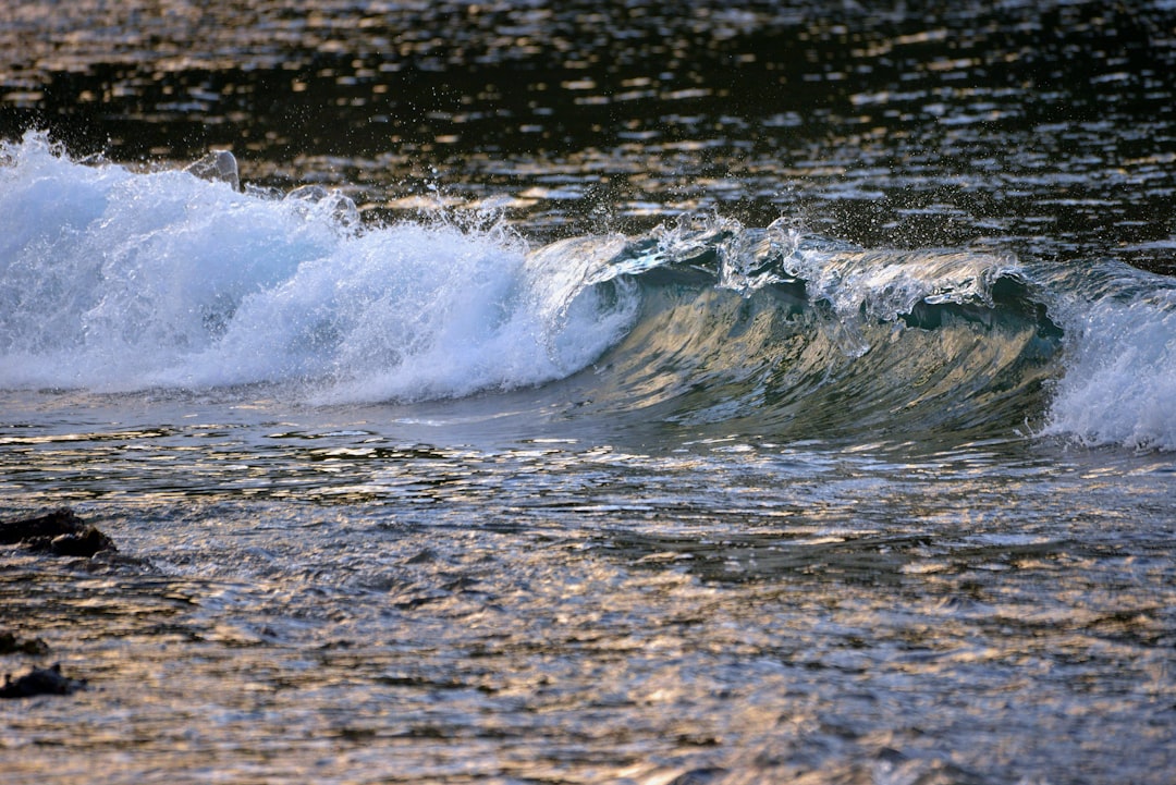 a wave crashing into a rock,