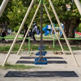 a swing set with people in the background