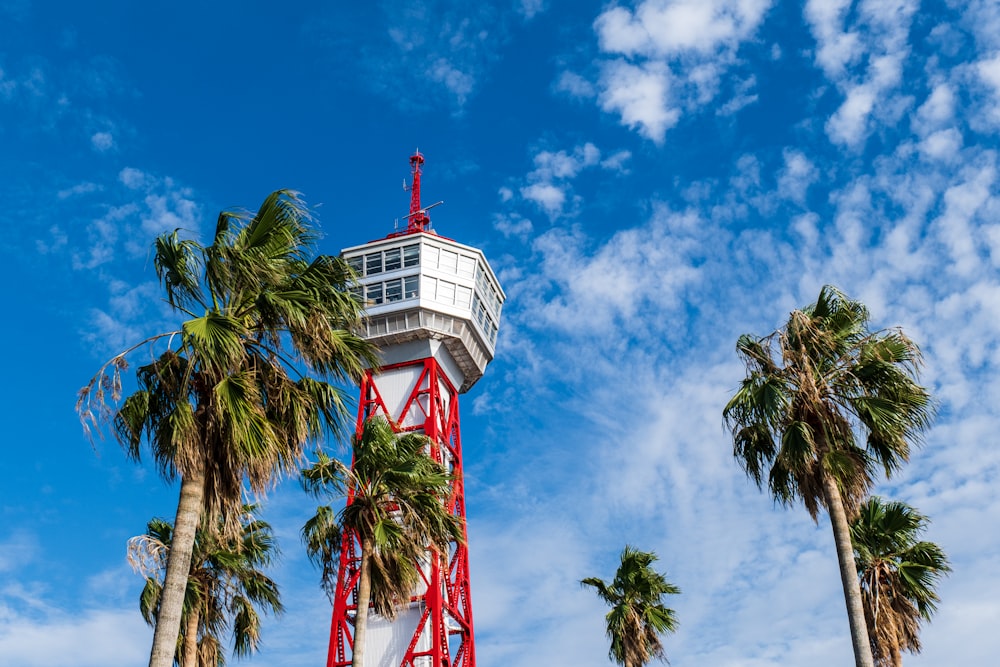 a lighthouse with palm trees