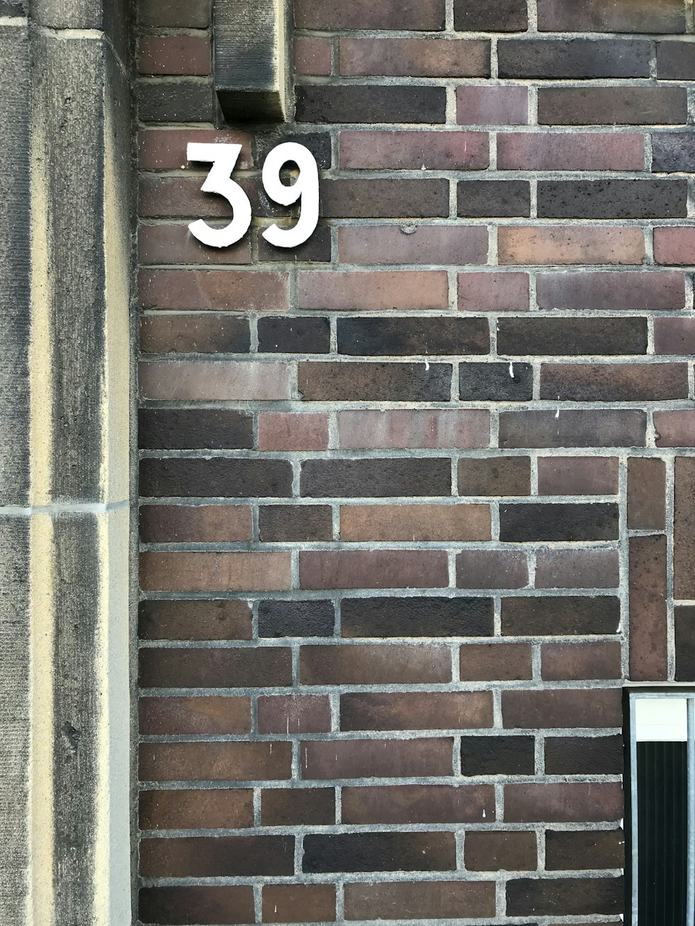 a brick wall with a sign on it