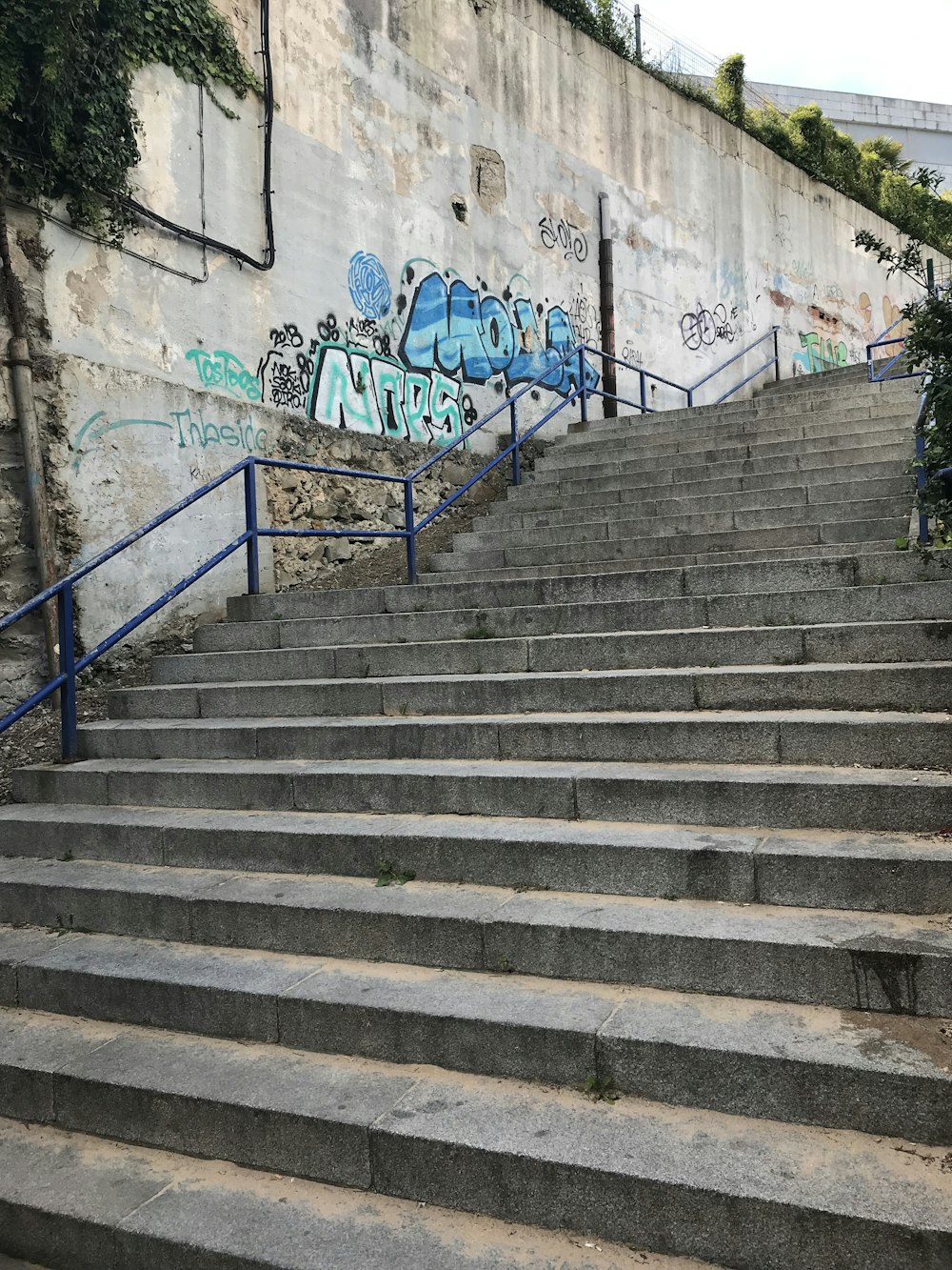 a set of stairs with graffiti on the walls