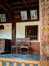 Wooden chair and table set in a non-AC room at Mallikarjuna Sadan.