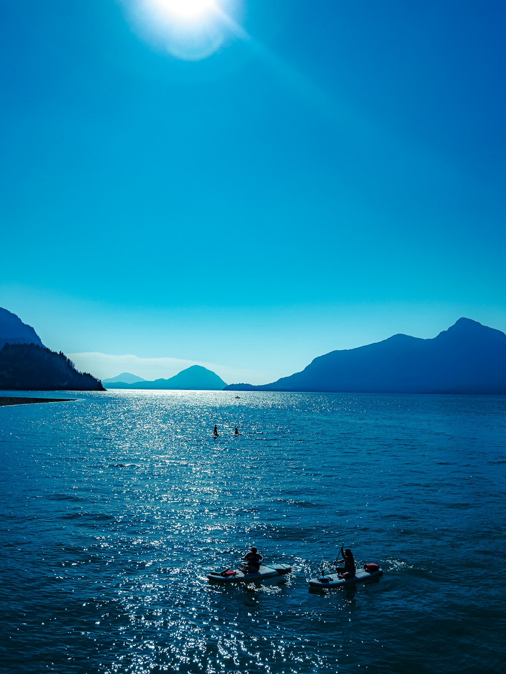 a group of people on small boats in a body of water