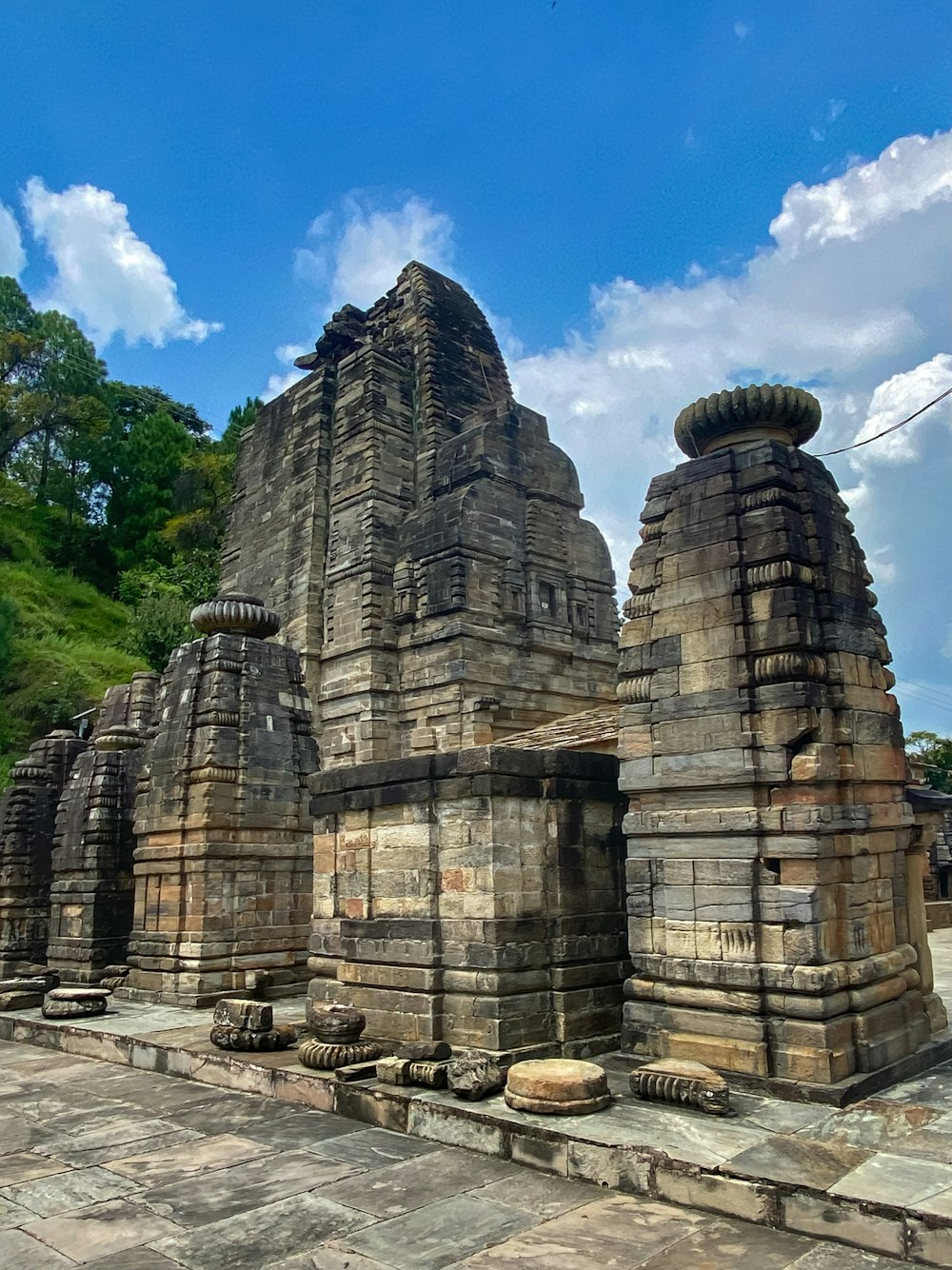 a stone building with a few towers with Konark Sun Temple in the background