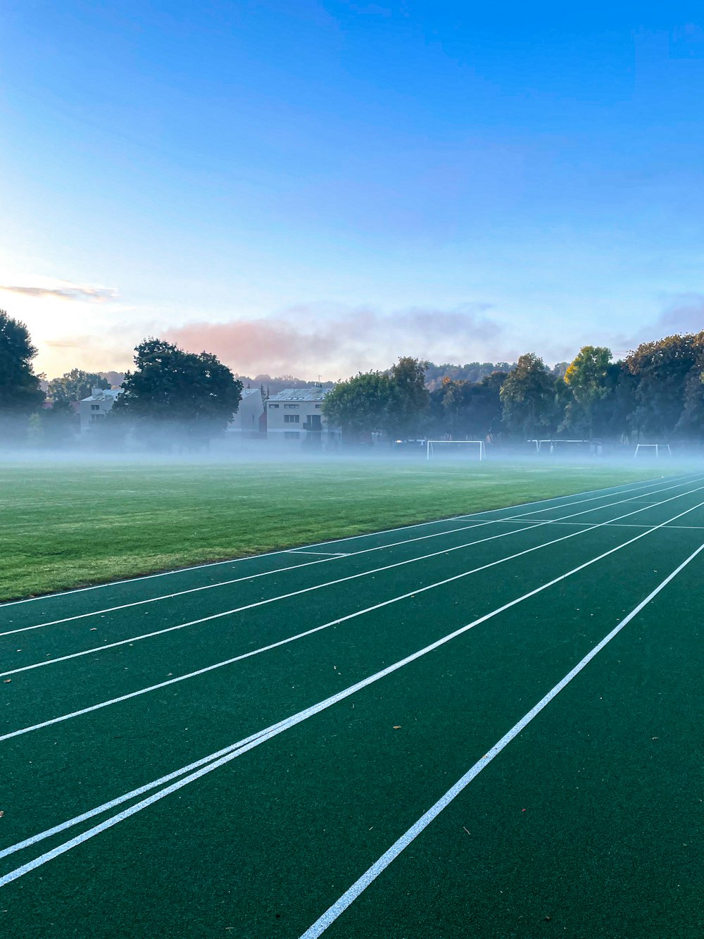 a football field with a fountain in the background