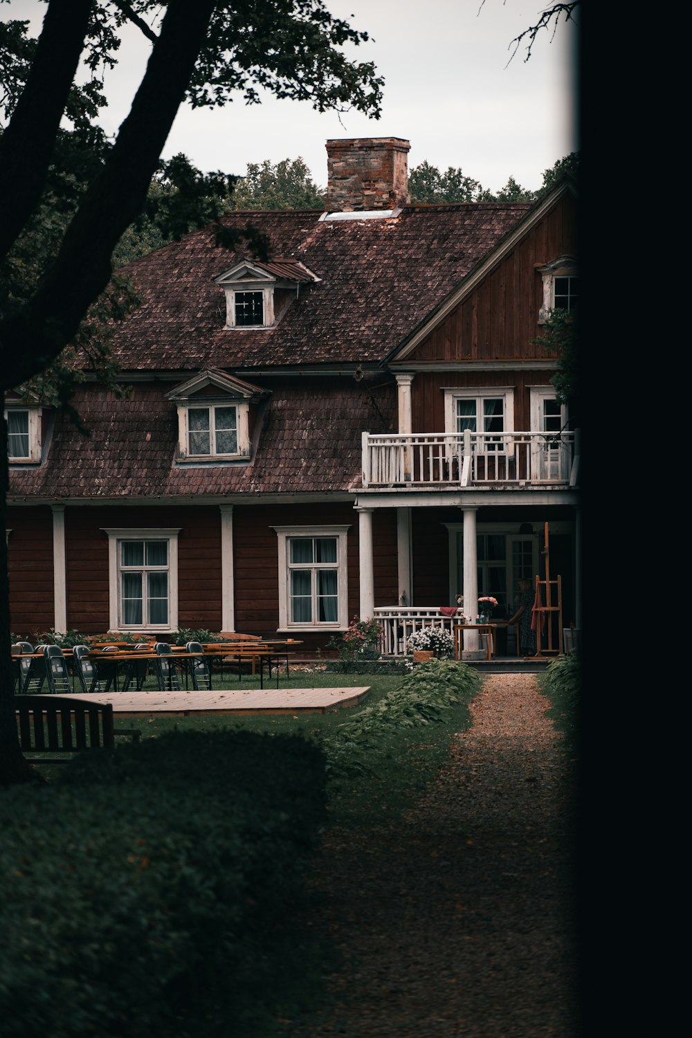 a brick house with a lawn and chairs in front of it