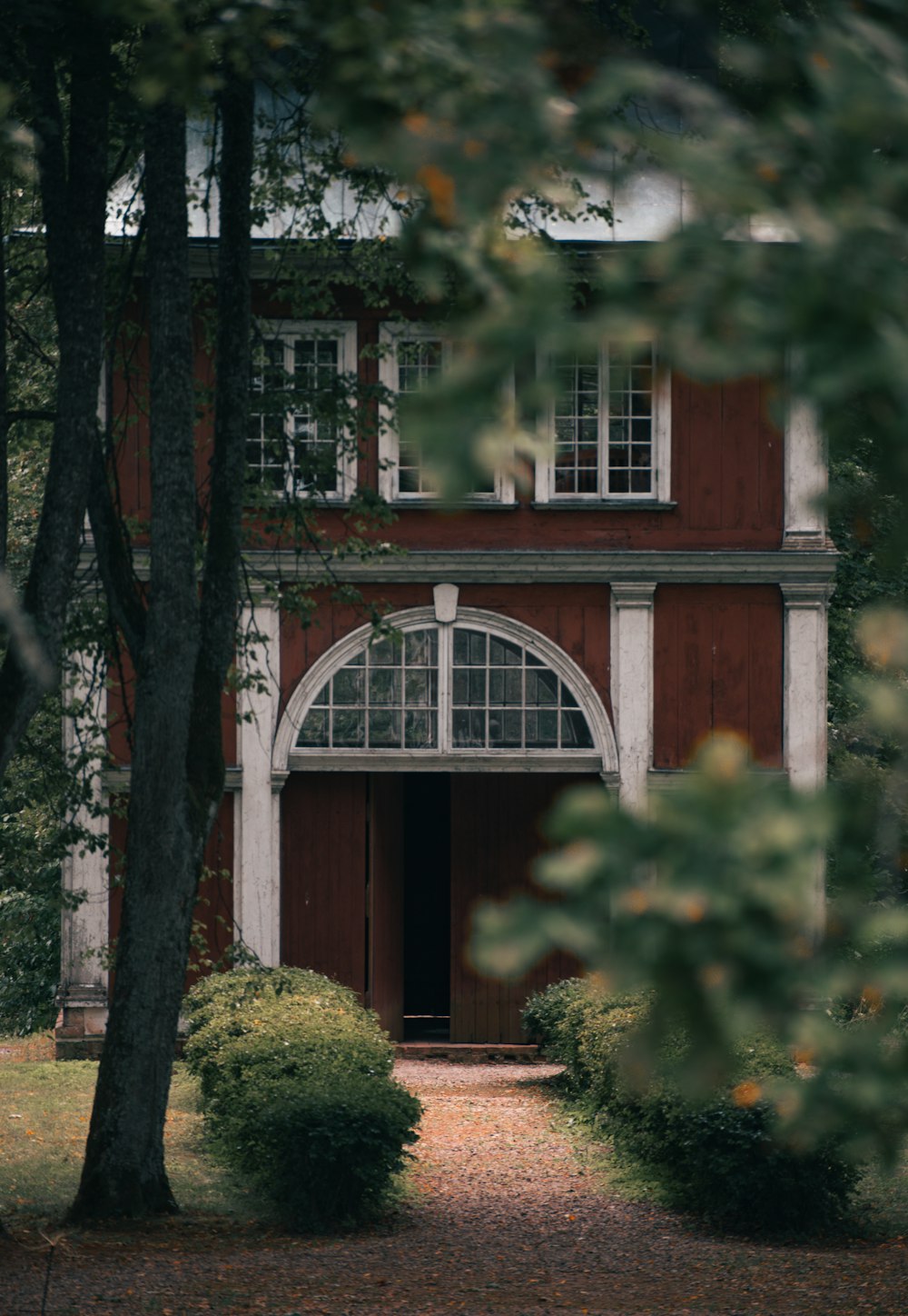 a brick building with trees in front of it