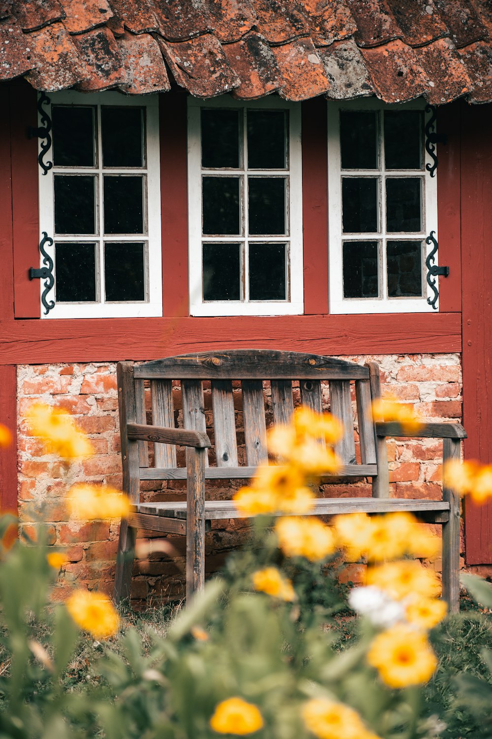 a red house with yellow flowers