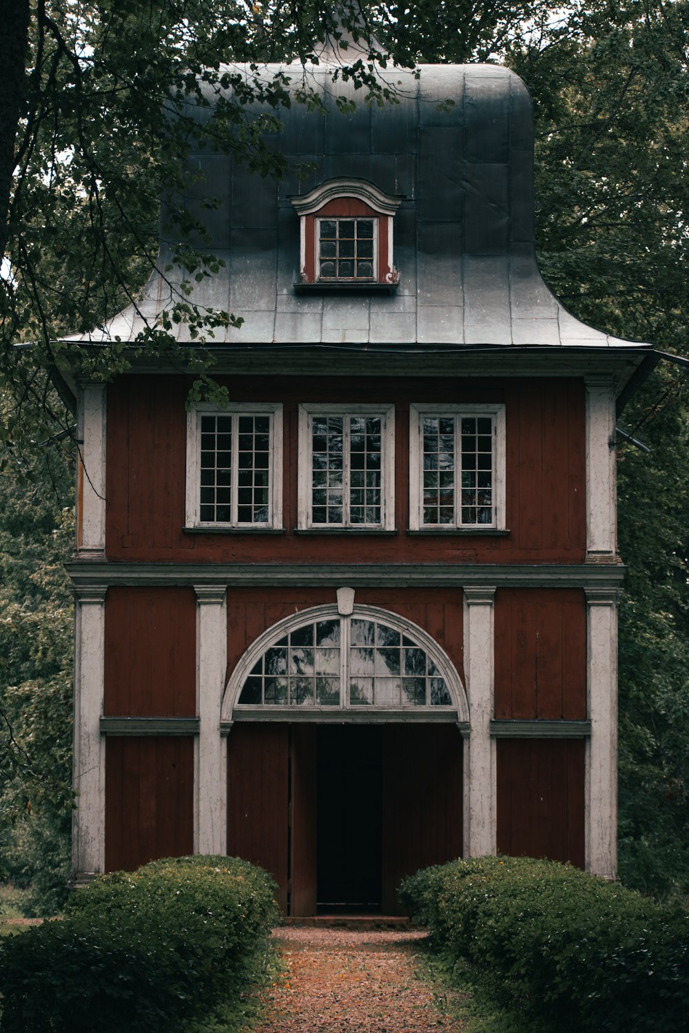 a small building with a large arched window