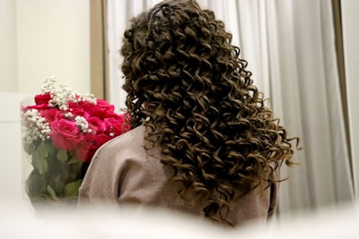 curly hair extensions and wig at Noelle Salon