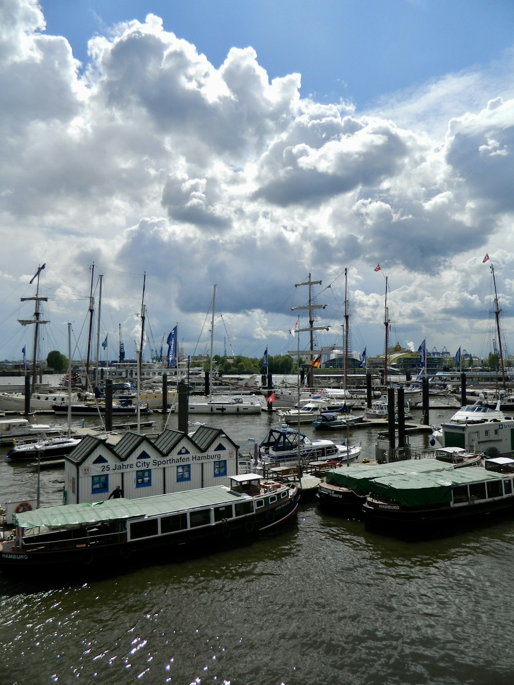 a group of boats sit in a harbor