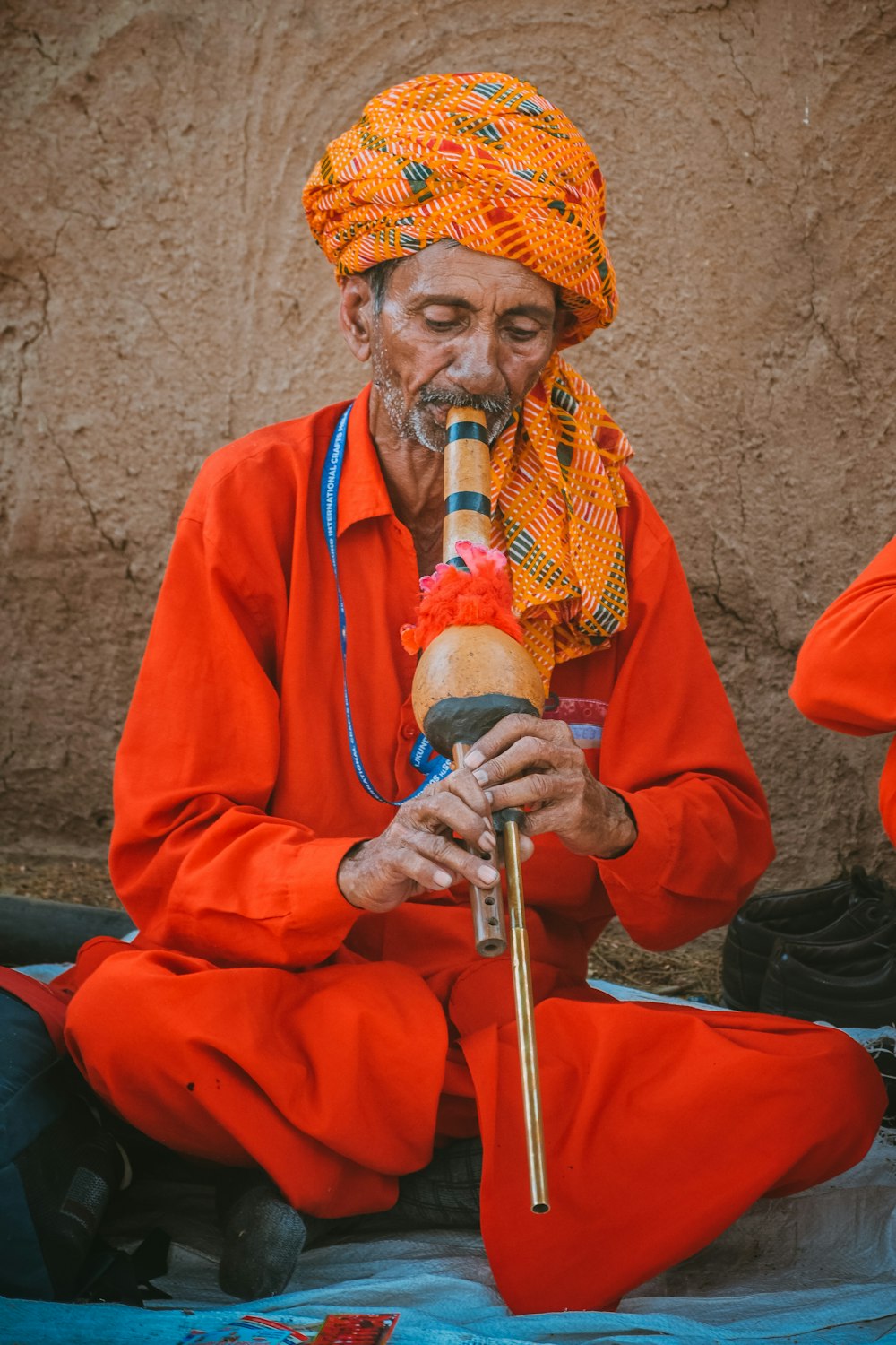 a man in a red robe holding a pipe