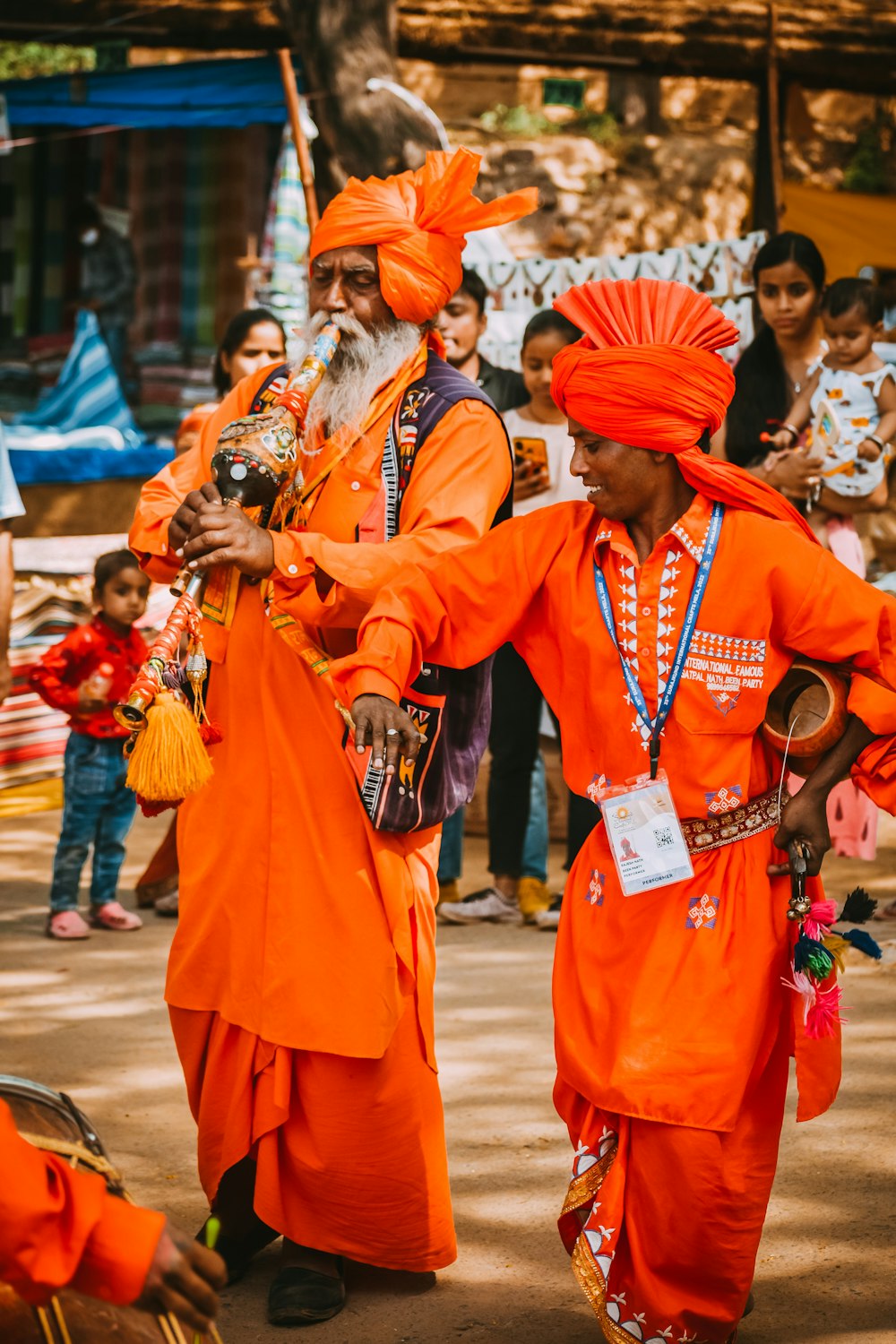 a couple of men in orange clothing
