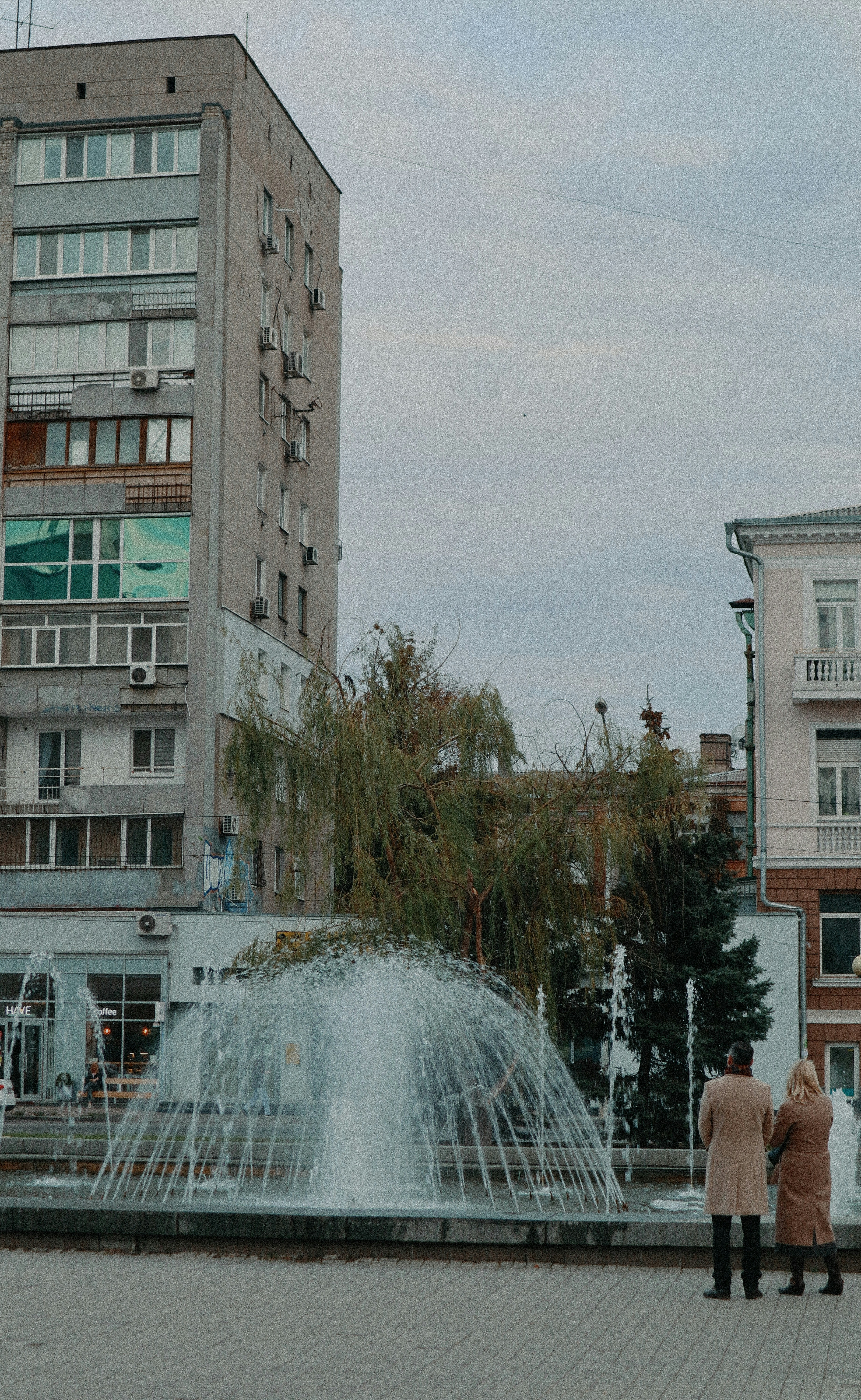 a fountain in a courtyard with buildings