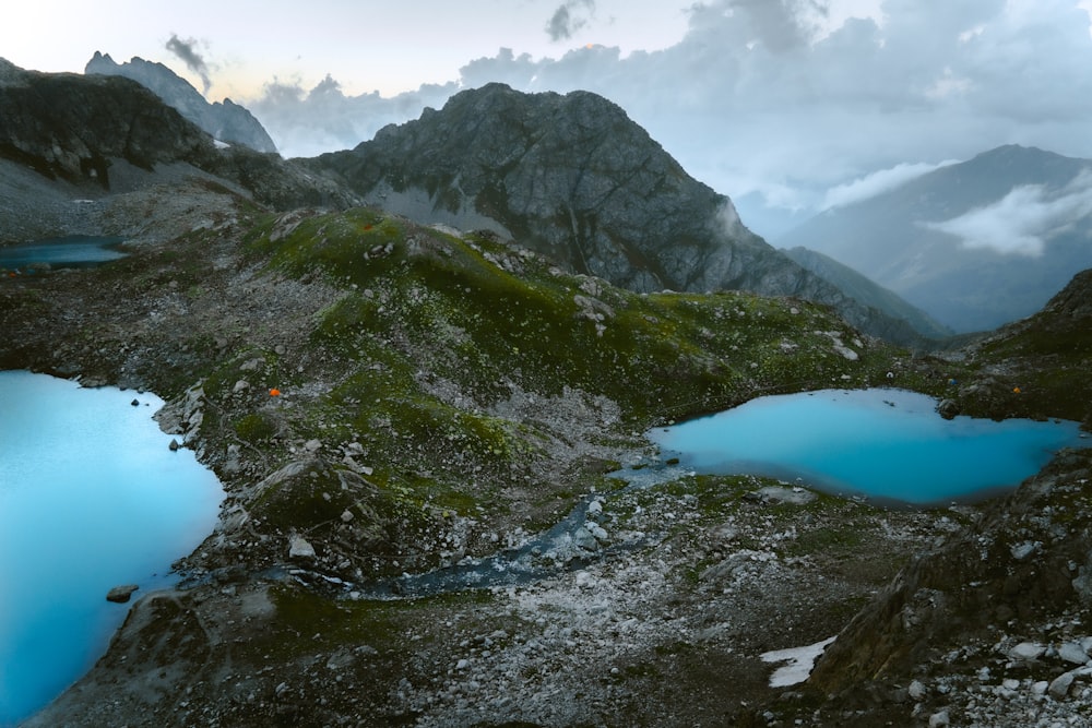 a body of water with mountains in the back