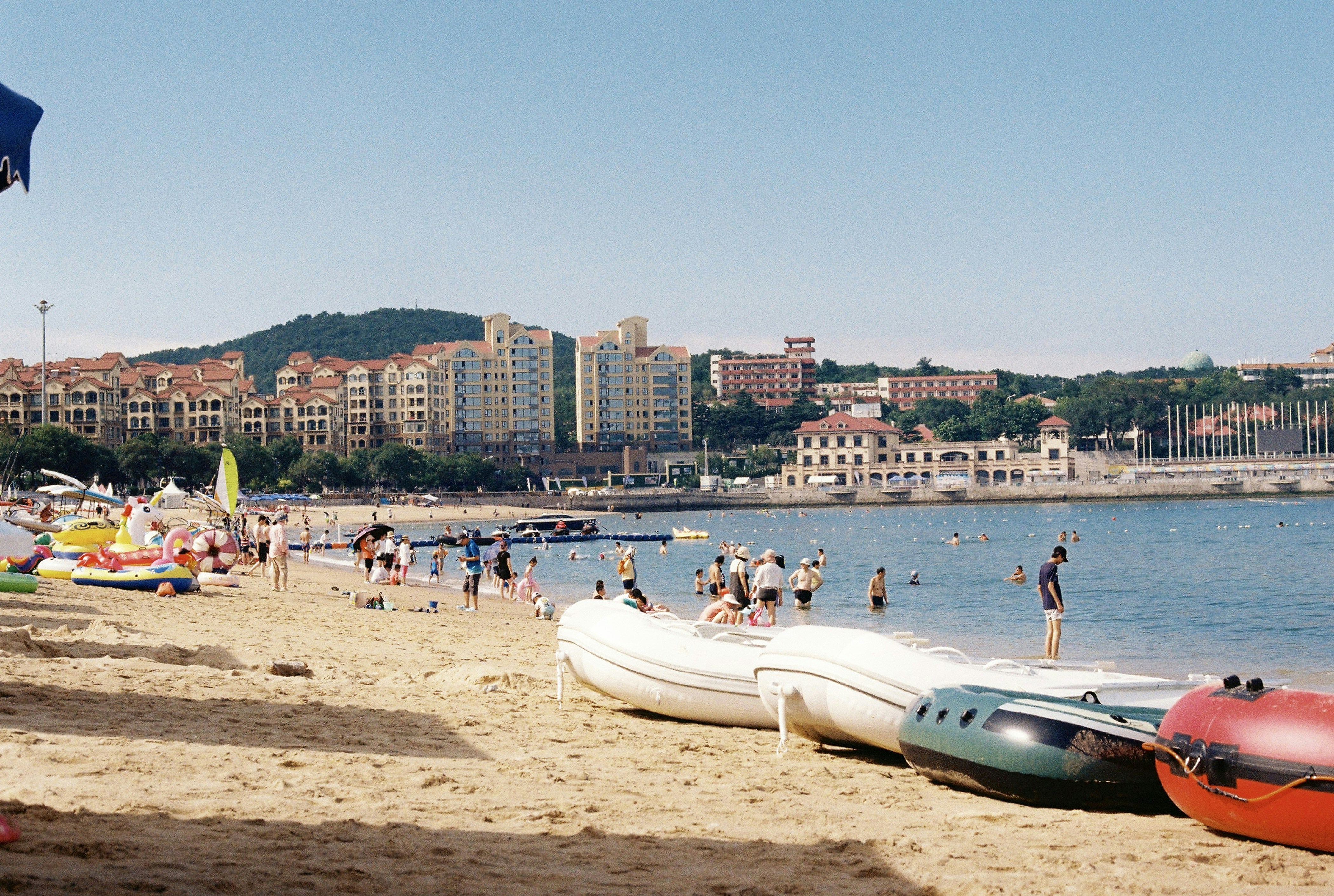 a beach with boats and people