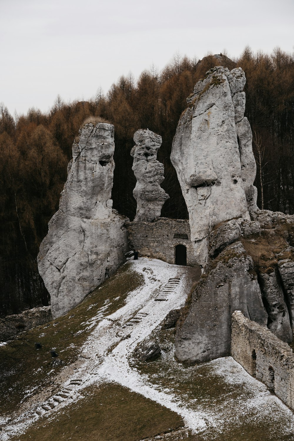 a group of large rocks in a snowy place