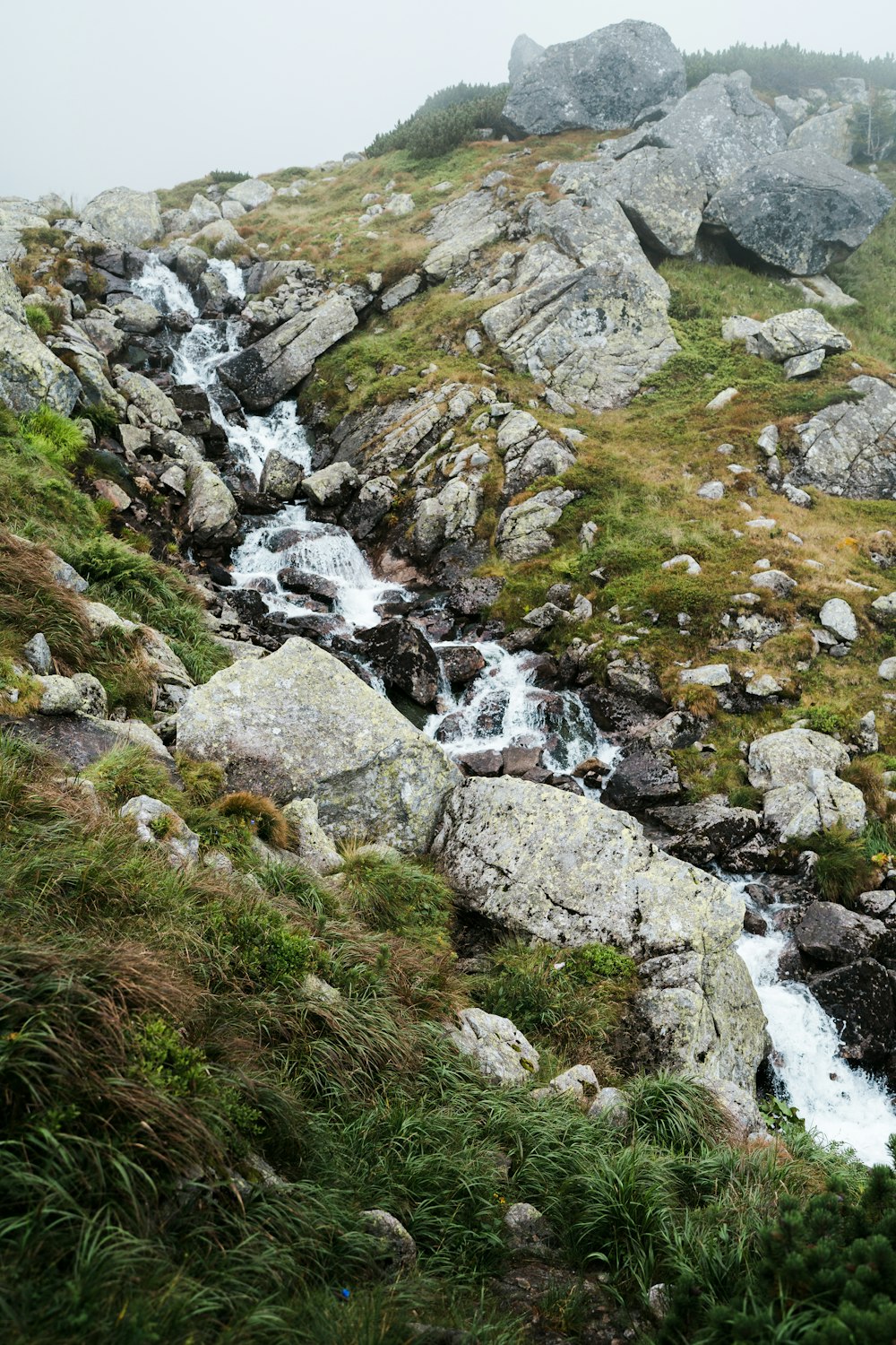 a rocky hillside with a waterfall