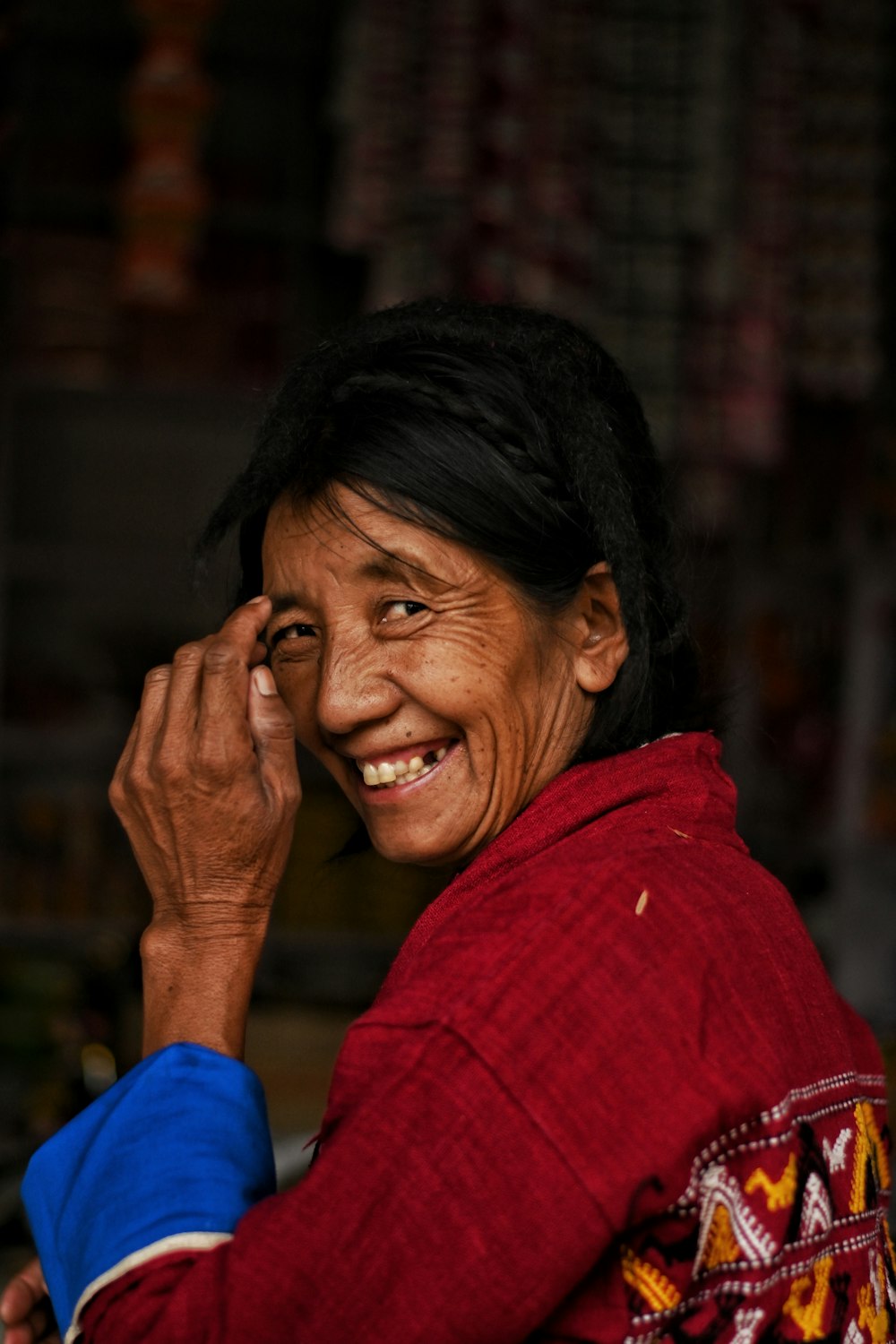 a person smiling with the hand on the face