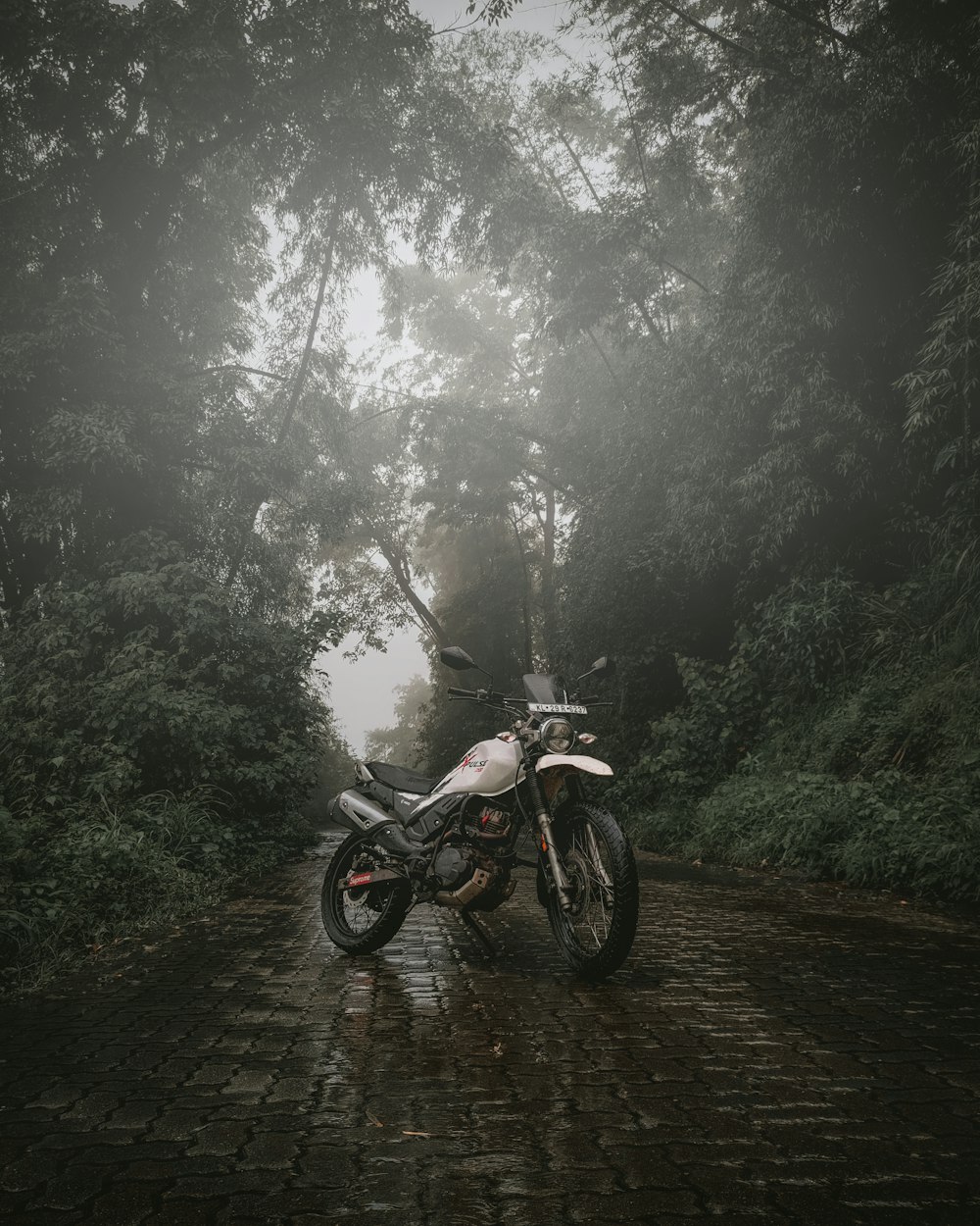 a motorcycle parked on a brick road