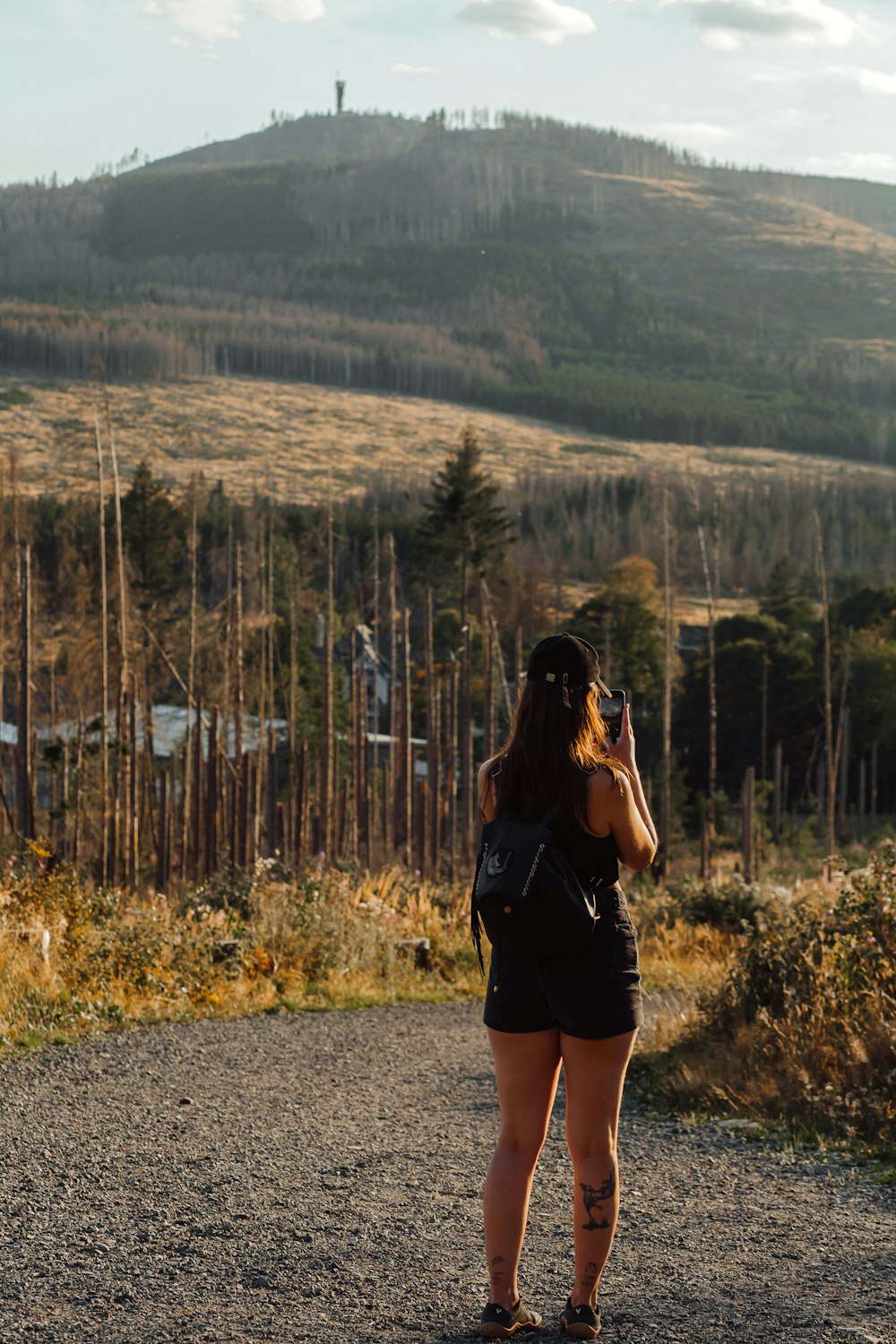 a woman standing on a hill