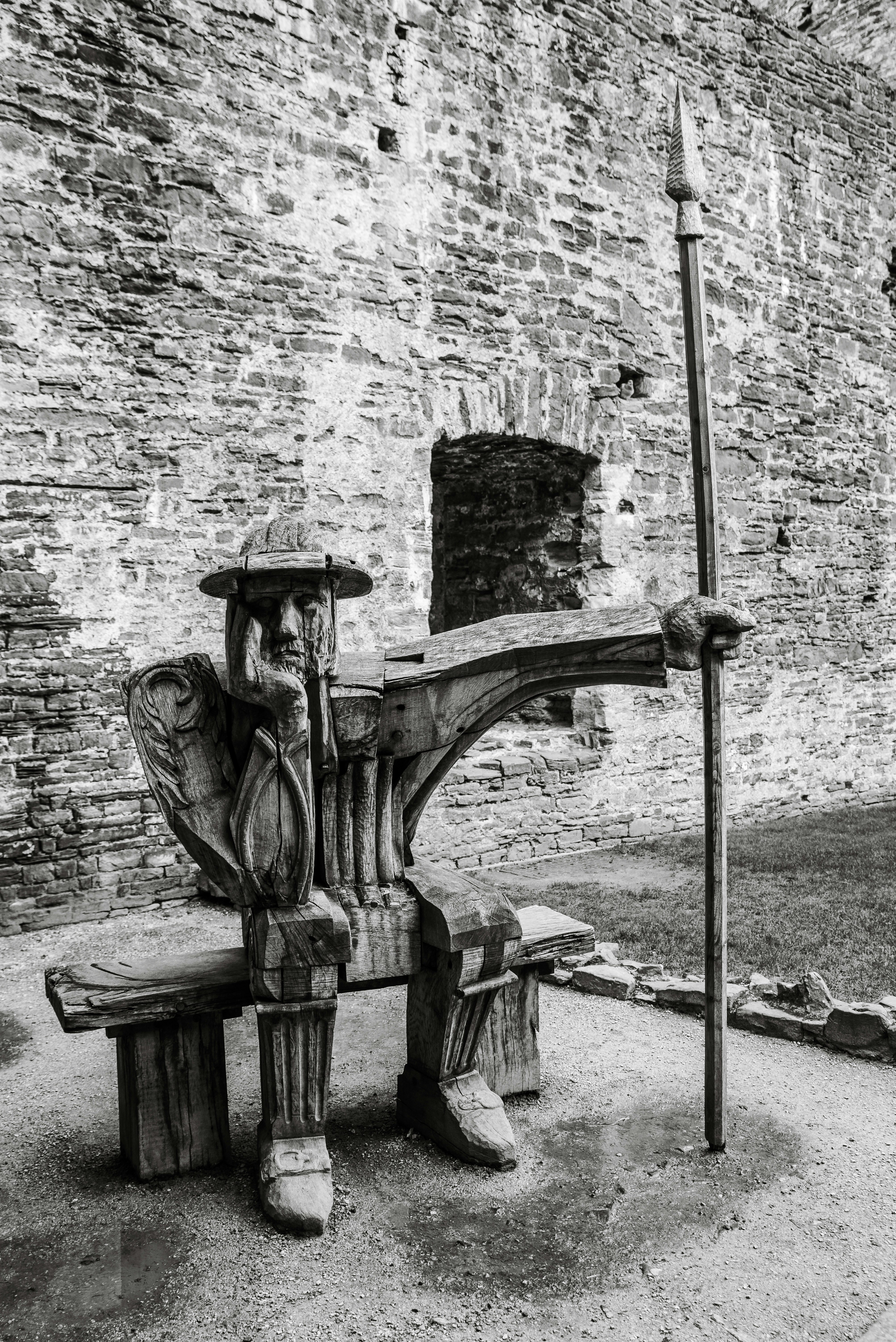 a bench in front of a brick wall