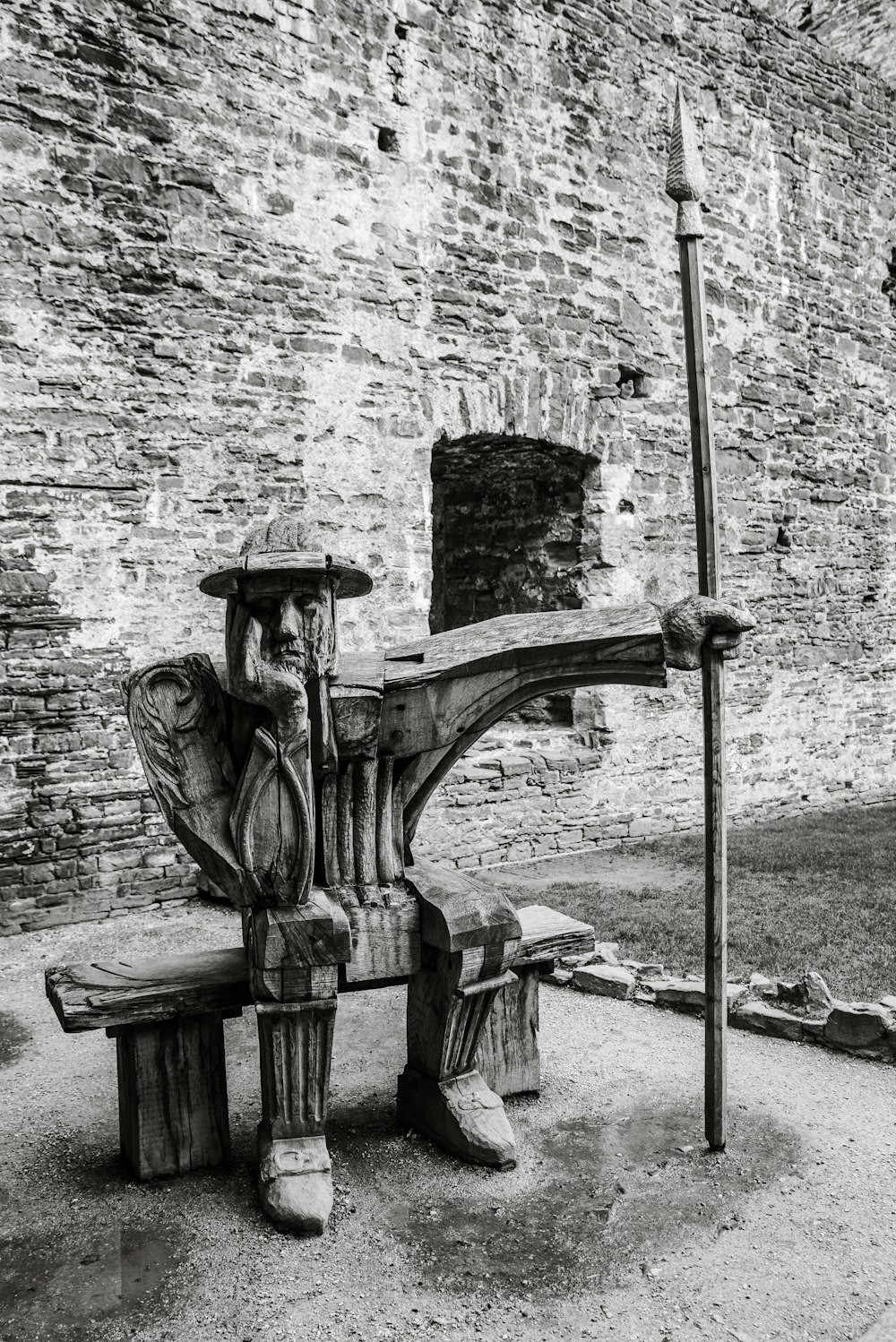 a bench in front of a brick wall