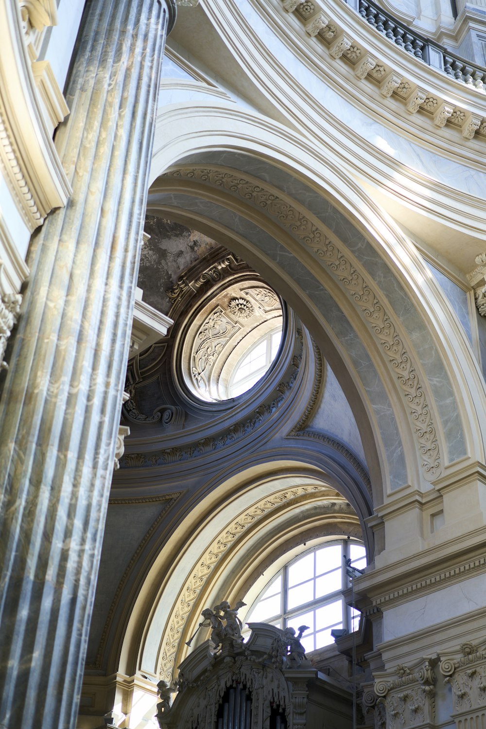 a large ornate ceiling with a statue