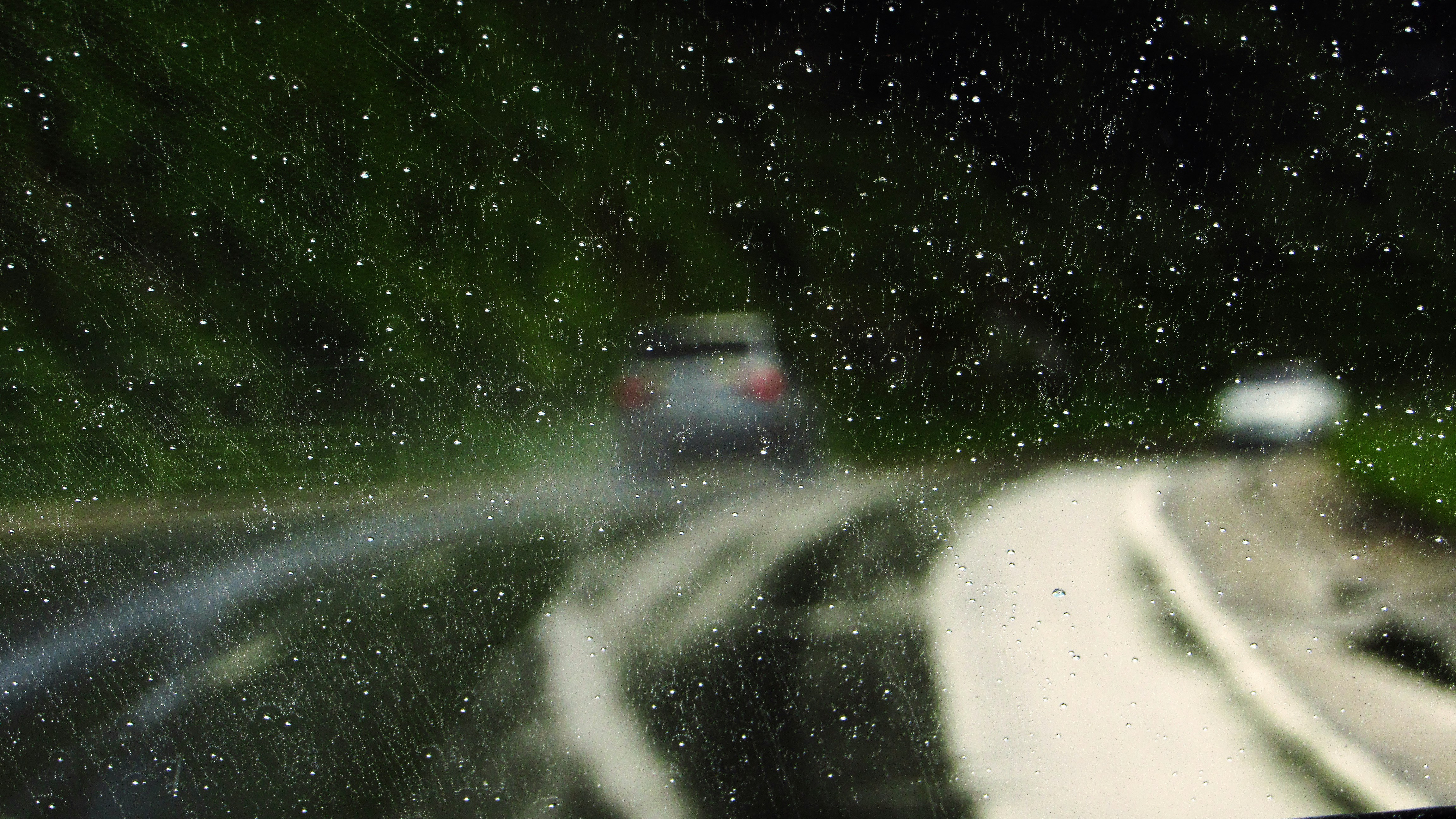 Electric car driving on a wet road, illustrating the importance of tire wet grip
